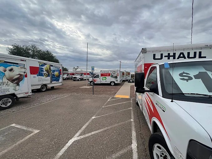Striped parking area beside the office with trucks nearby