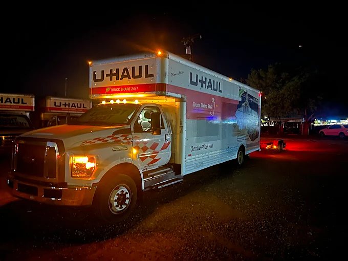 U-Haul truck with running lights on at night
