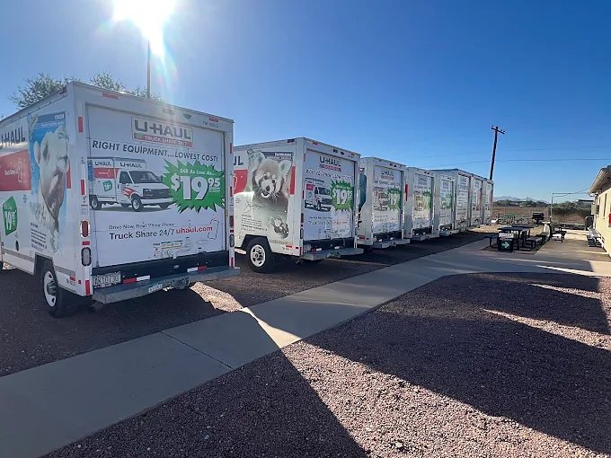 Rear of U-Haul trucks lined up beside the walkway